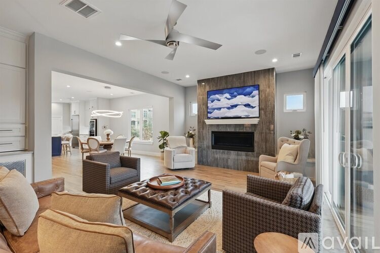 A modern living room with a fireplace and a television.