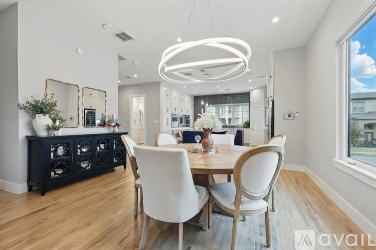 A modern dining room with a wooden table and chairs.