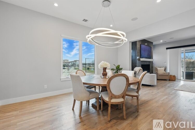 A modern dining room with a large table and chairs.