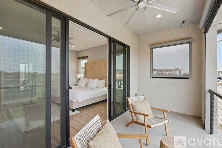 A bedroom with a bed, chair, and window.