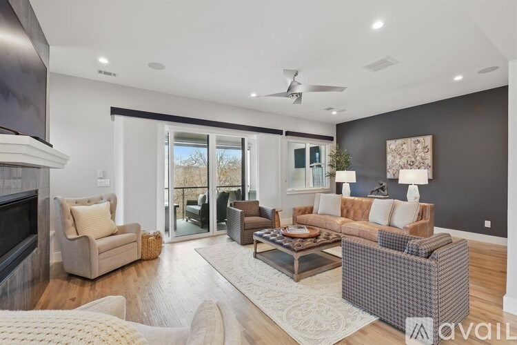 A living room with a fireplace, a couch, a chair, and a coffee table.