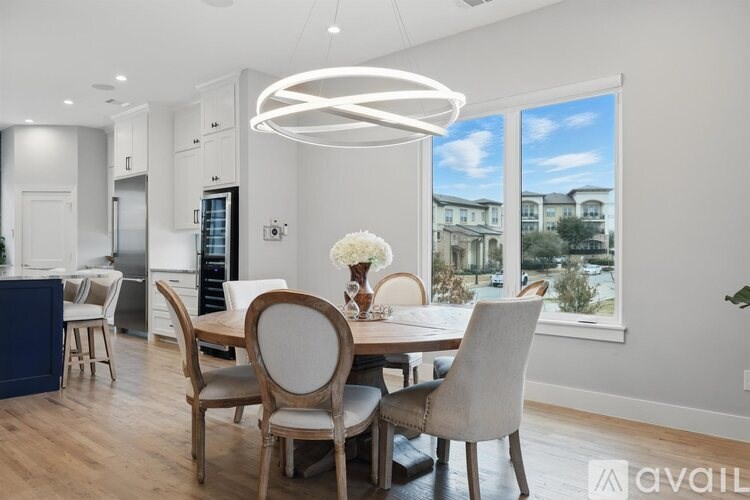 A modern dining room with a table set for four.