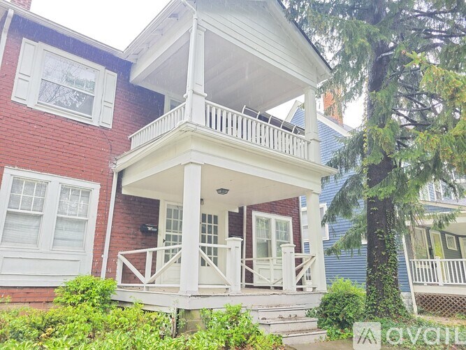A red and white house with a balcony.