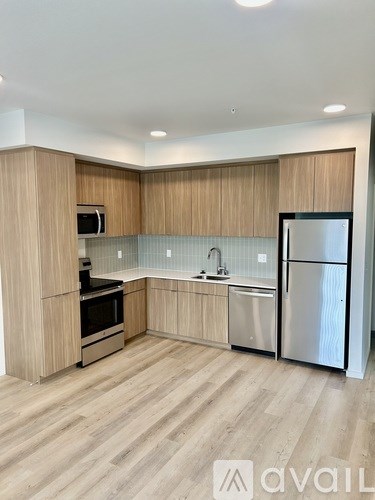 A kitchen with wooden cabinets and stainless steel appliances.
