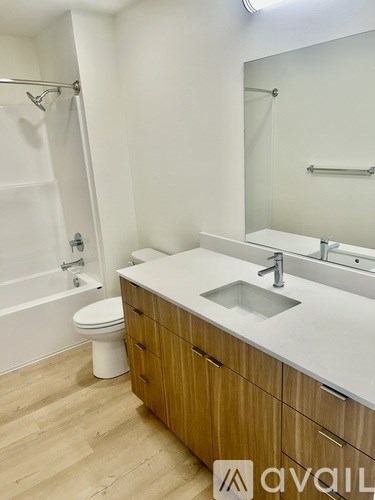 A bathroom with a sink, toilet, and bathtub.