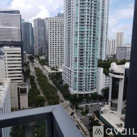 A cityscape with a tall building in the center and a street below.