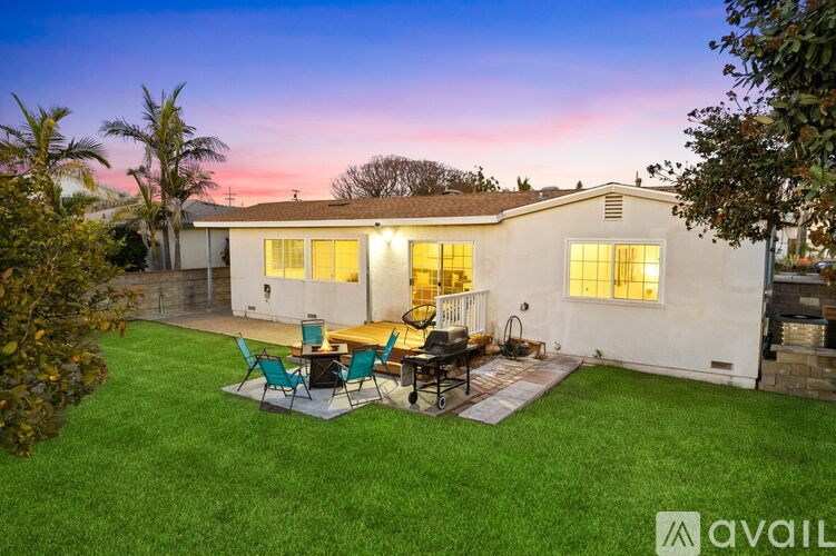 A house with a patio and lawn is available for rent.