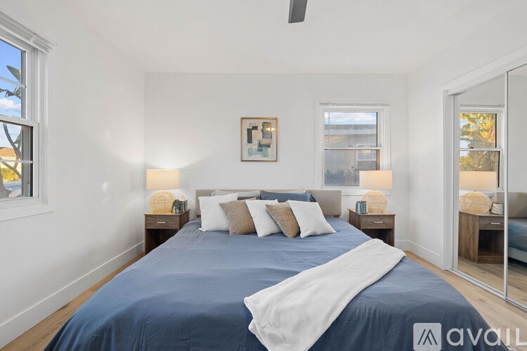 A bedroom with a large bed and a mirror on the wall.