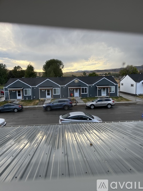 A parking lot with cars and a building in the background.