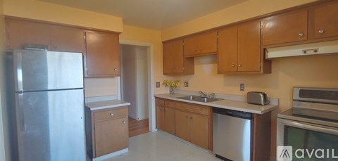 A kitchen with wooden cabinets and stainless steel appliances.