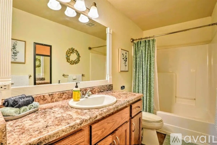 A bathroom with a marble countertop and a white sink.
