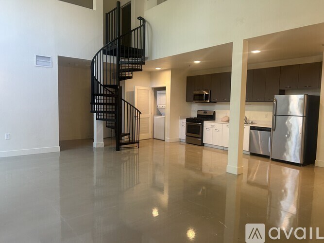 A living room with a couch, chairs, and a dining table.
