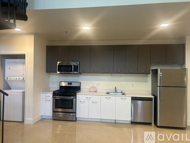 A living room with a white couch and a blue chair.
