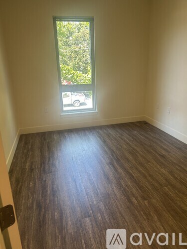 A living room with a grey sofa and a black chair.