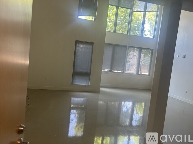 A living room with a staircase on the left side.