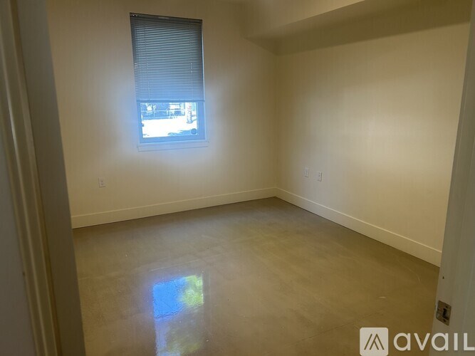 A living room with a spiral staircase in the background.