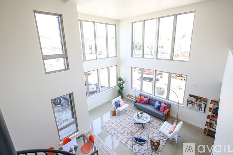 A living room with a couch, chairs, and a coffee table.