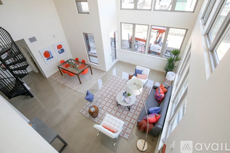 A living room with a couch, chairs, and a coffee table.