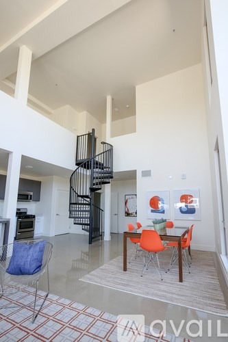 A living room with a spiral staircase in the middle.