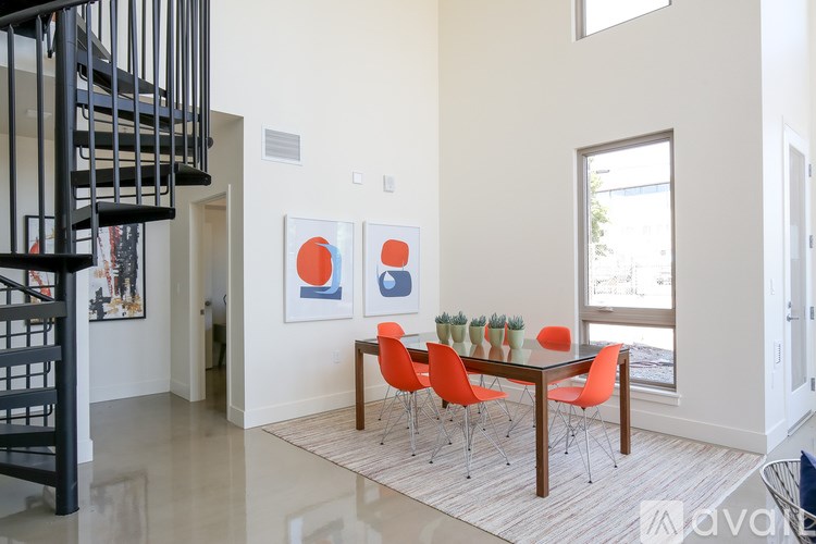 A dining room with a table and chairs.