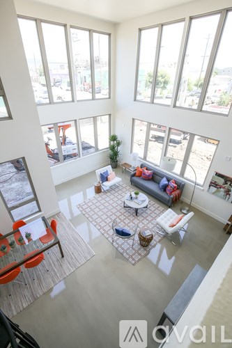 A living room with a couch, chairs, and a coffee table.