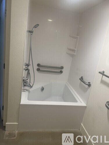 A living room with a spiral staircase in the background.