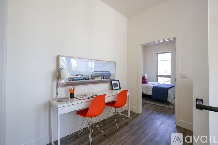 A room with a desk and a bed.