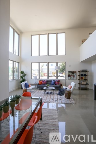 A living room with a couch, chairs, and a coffee table.
