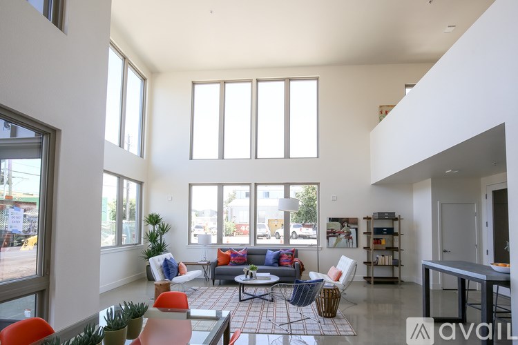 A living room with a couch, chairs, and a coffee table.