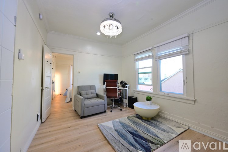 A living room with a grey sofa and a white table.