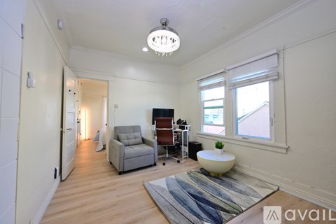 A living room with a grey sofa and a white table.