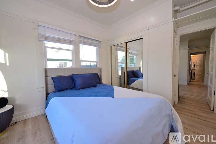 A bedroom with a large bed and a round window.