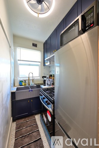 A bathroom with a black sink and a white tub.