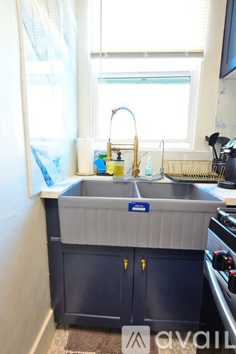 A kitchen sink with a blue label on it.