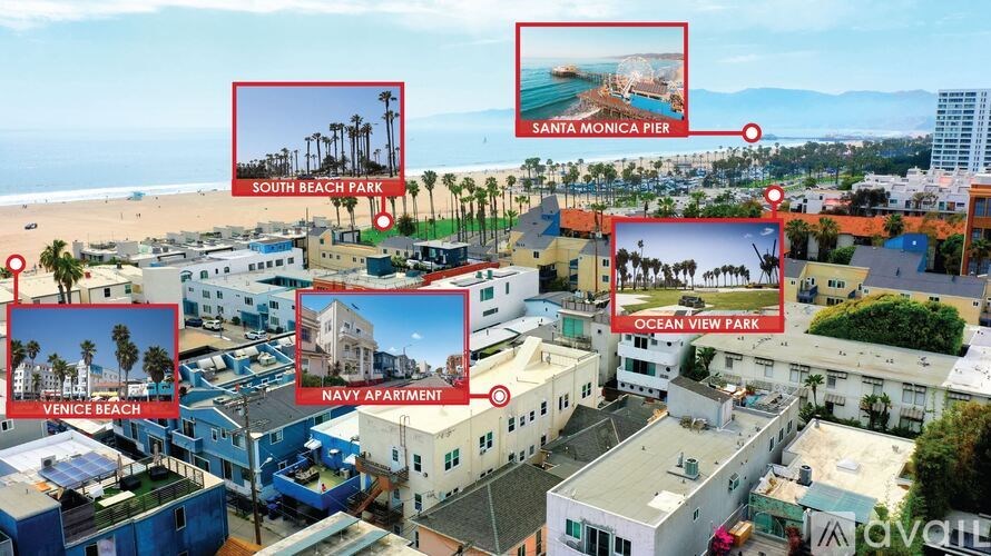 A living room with a grey couch, a white table, and a window with a view of the outside.