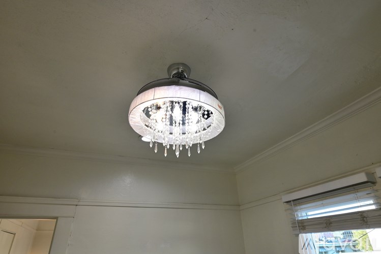 A ceiling light with a white shade and clear glass.