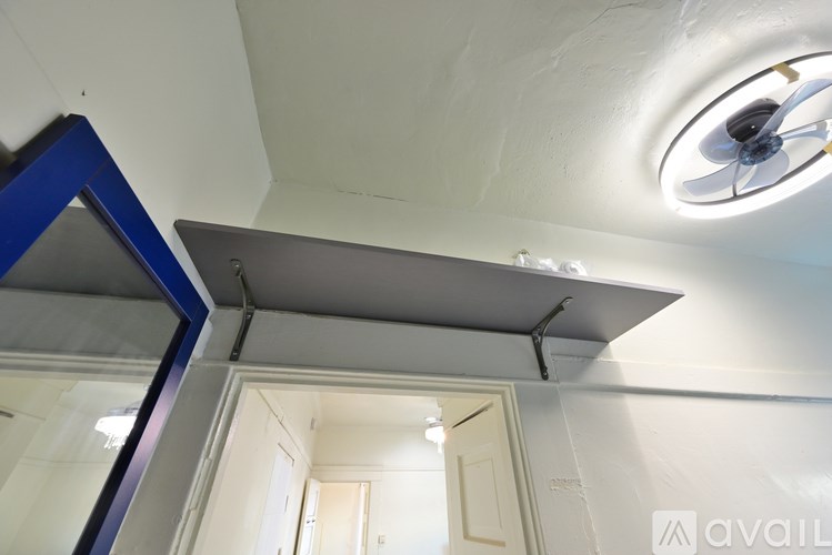 A ceiling fan is mounted on a white ceiling.