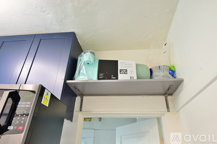 A kitchen with a microwave, oven, and cabinets.