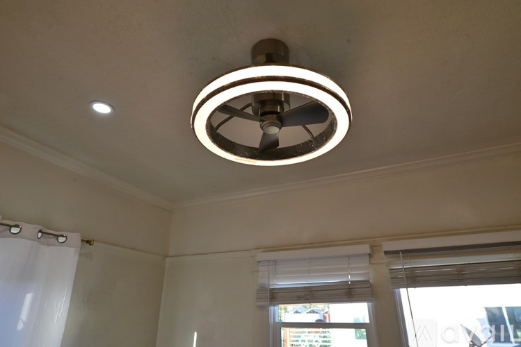 A ceiling fan with a light fixture mounted on a white ceiling.
