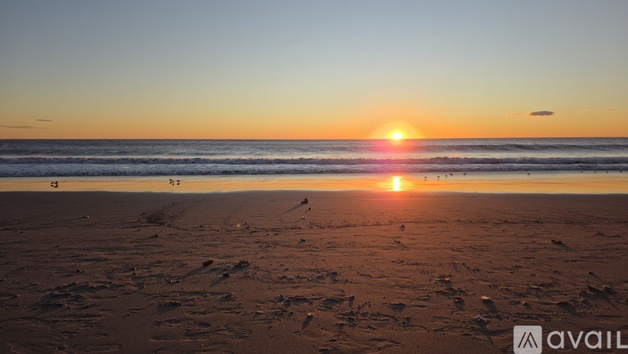 A bedroom with a bed, a window, and a lamp.