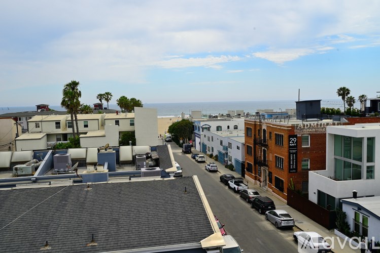 A view of a street with cars and buildings.