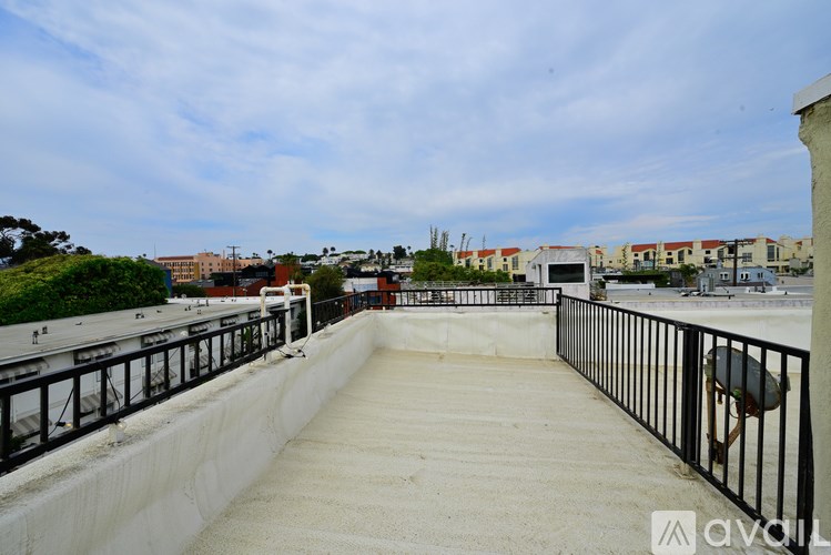 A concrete pathway with a metal railing on the right side.