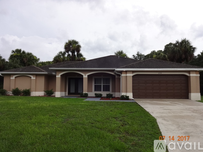 A house with a brown garage door is for sale.
