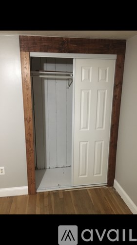 A white door with a mirror above it.