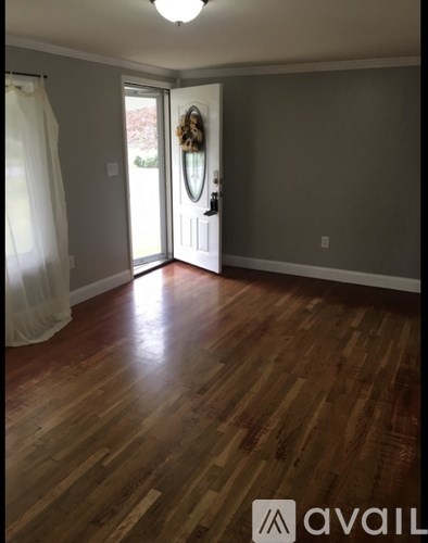 A room with wooden floors and a white door.
