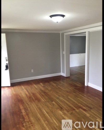 A room with wooden flooring and a light on the ceiling.