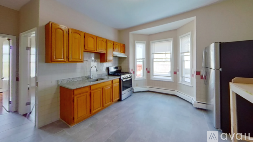A kitchen with wooden cabinets and a marble countertop.