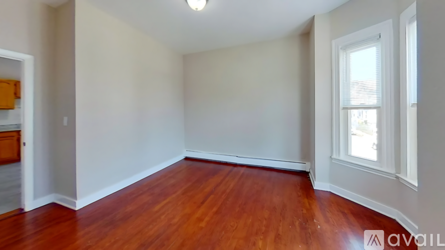 A room with wooden floors and white walls.