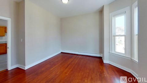 A room with wooden floors and white walls.