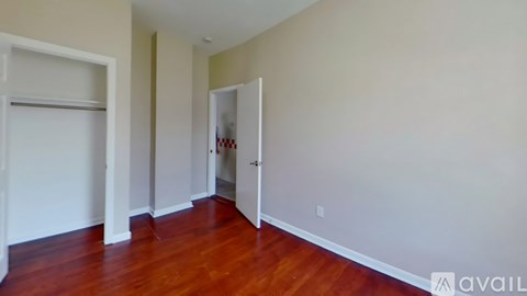 A room with wooden floors and white walls.